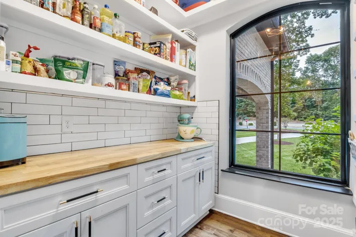 Built in cabinets and shelves provide lots of storage space in the walk-in pantry.