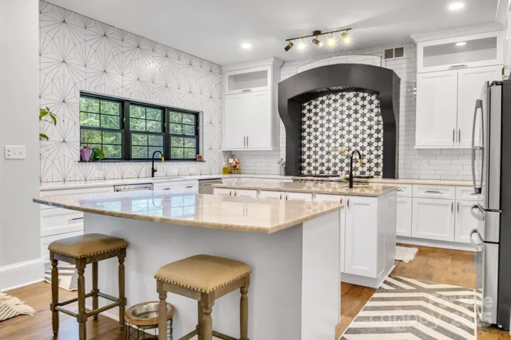 Large gourmet kitchen with two islands, double dishwashers and commercial grade range hood fan.