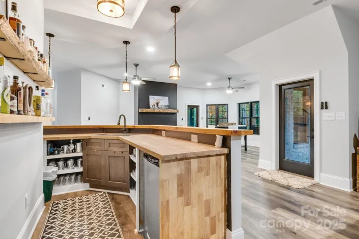 Wet bar has ample storage and custom built-ins.