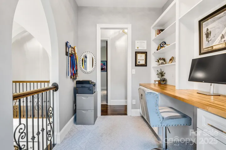 Second floor office with Juliet balcony overlooks the dining room below. Custom cabinets and shelves provide lots of work and storage space.