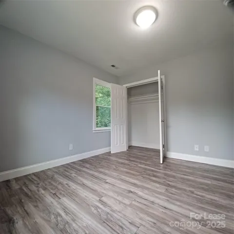 Corner secondary bedroom with double door closet