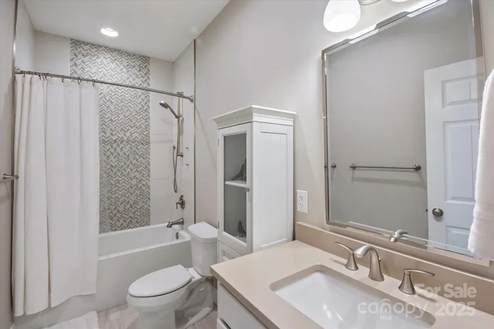 Updated guest bath with beautifully tiled shower
