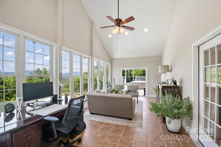 Four season room also leads out to expansive deck and hot tub.