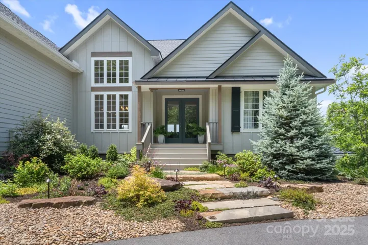 Lovingly cared for landscaping and inviting stone walk way will be your guests first impression.
