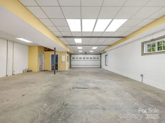 Huge basement with double garage door. Full bath on the left.