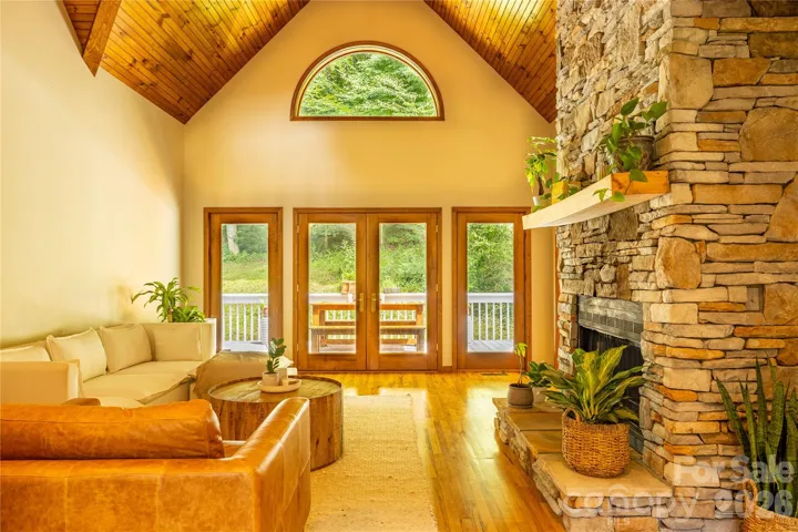Great room with cathedral ceiling and stone fireplace