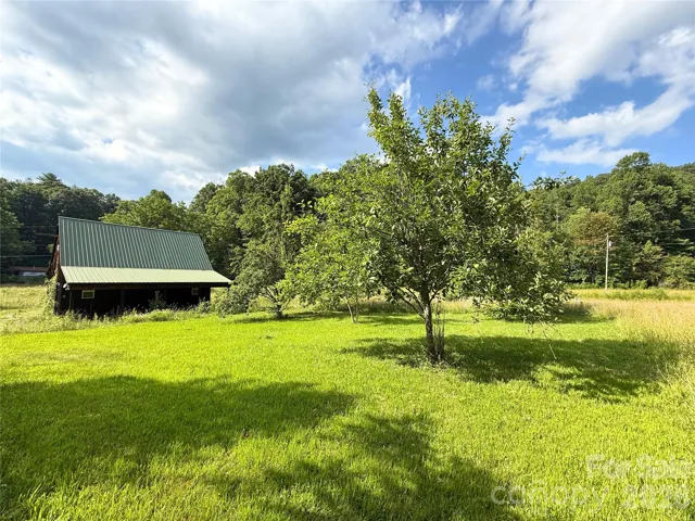 View of barn with pasture and orchard