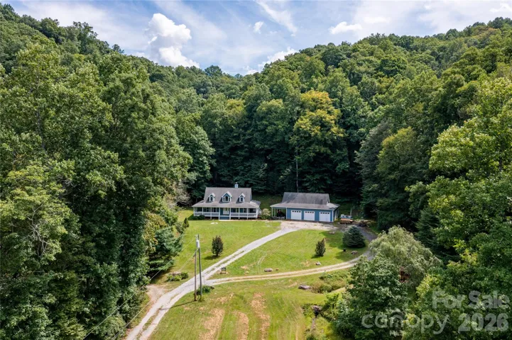 Aerial photo of the front pasture and home with massive garage and workshop