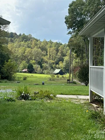 View looking onto pasture and barn in distance from the side of home