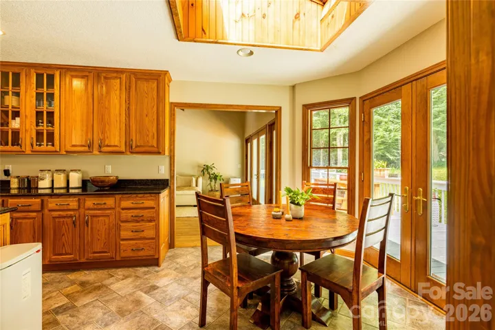 Dining table off kitchen with skylight overhead
