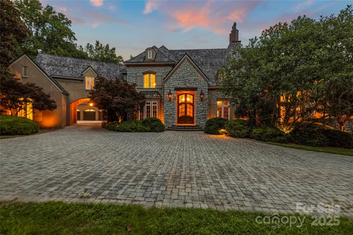 Grand Entrance & Timeless Curb Appeal! A cobblestone circular drive welcomes you to this custom crafted estate with stone accents, dormer windows, and a stately entrance