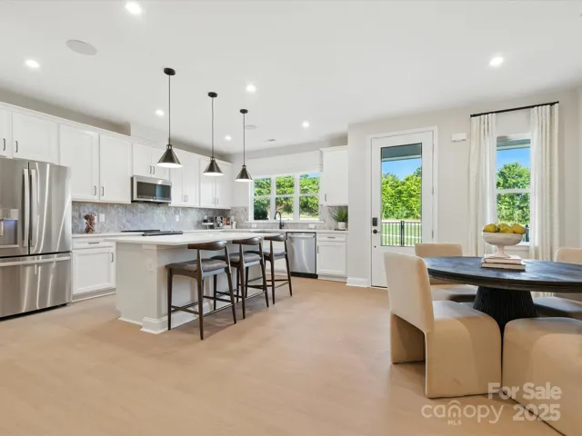 Step inside through the front entry and be greeted by the kitchen and dining space. *Model Photos | Actual finishes, structural selections, and orientation may vary.