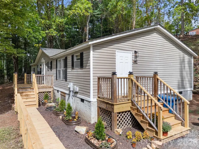 New walkway, side porch, deck and adorable landscaping.