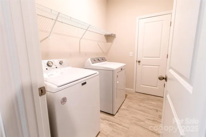 Laundry room off Primary room and hallway