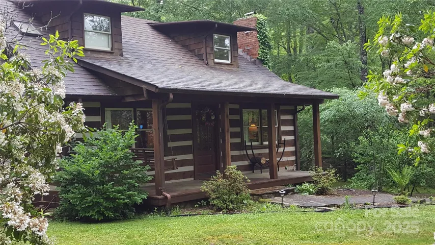 The front door and front porch with a swing.