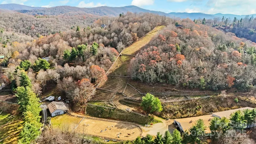21+ acres with two barns, living quarters, riding rings, & fenced pastures