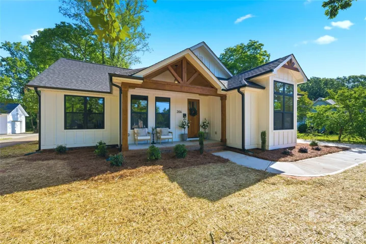 Modern farmhouse charm meets timeless small-town living in the heart of McAdenville. Featuring striking timber accents, black windows, an inviting covered front porch, and beautiful architectural details, this move-in-ready home offers warmth, character, and curb appeal from the moment you arrive.