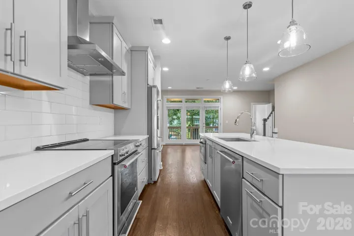 Beautifully designed kitchen with sleek finishes, subway tile backsplash, and an oversized island that connects seamlessly to the open living area.