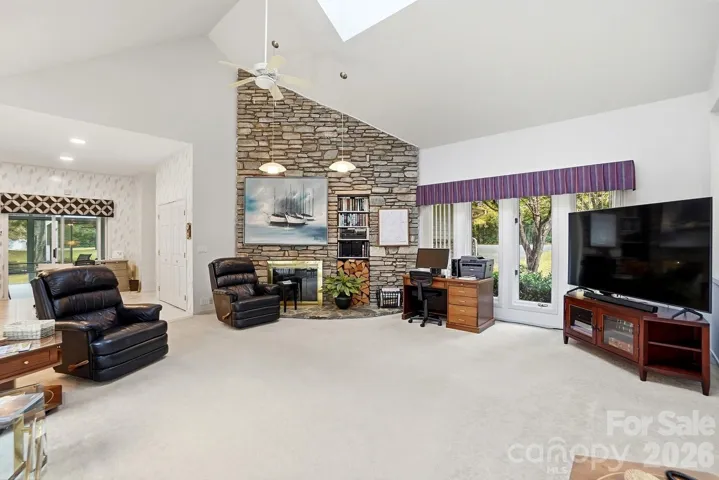 Stone Wall with a fireplace in the front living room is located adjacent to the kitchen.