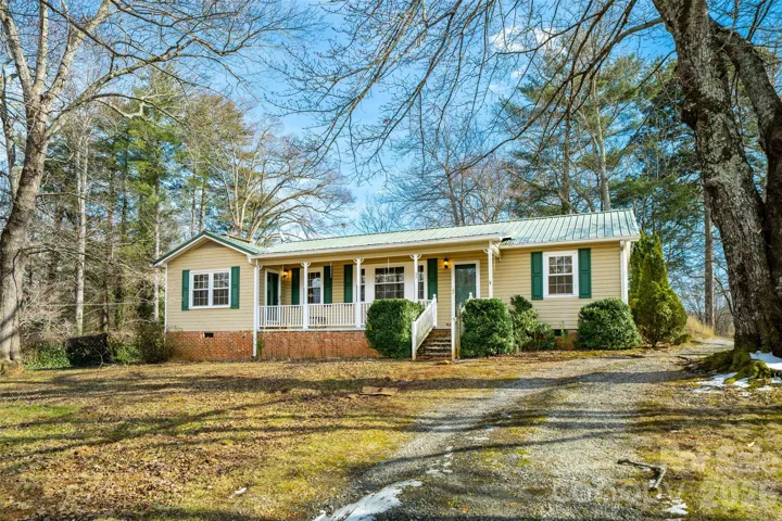 Front of the home and gravel driveway