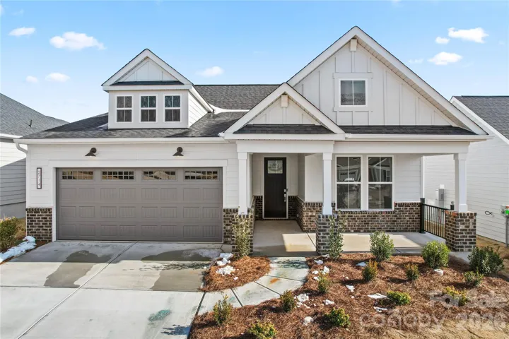 Inviting exterior with large front porch and brick accents