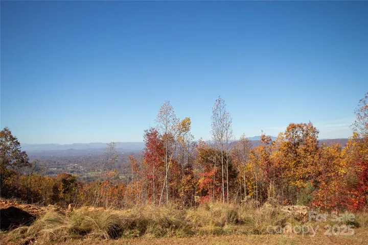 Clearing still in progress but view includes Mt Mitchell, Table Rock, Hawksbill, Grandmother and Grandfather (behind trees)
