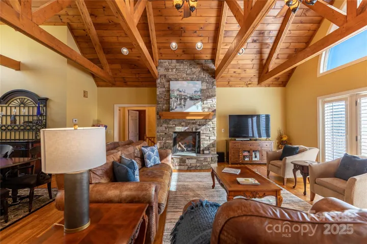 Floor to ceiling stacked stone fireplace makes for cozy gathering spot 