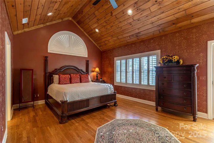 Fit for a king! The main level master suite has valuted wood ceiling , beautiful hardwood floors and adjoining walk in closet and bath