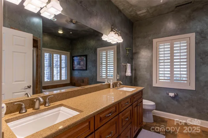 Master bath has dual granite counters with two under mount sinks, tile floors and separate jetted tub and shower. 