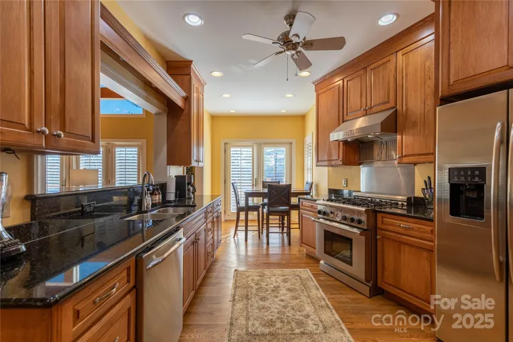 What a fabulous kitchen! Thermador gas range, granite counters, stainless appliances and tons of beautiful cabinets
