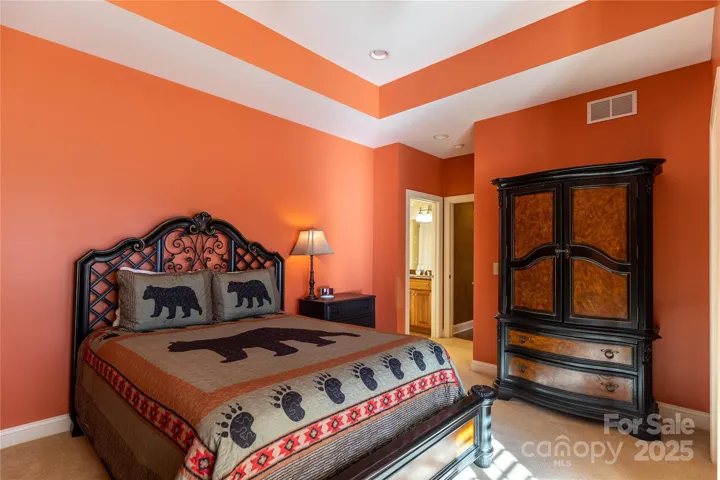 Affectionately called the bear room this large bedroom on lowr level has access to lower deck, big walk in closet and cheerful paint color. 