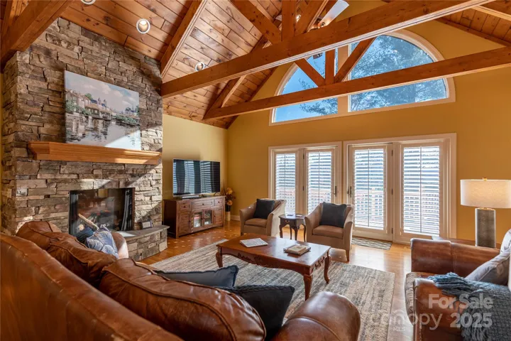 Fabulous family room has real wood cathedral ceiling with handsome beams and paladium windows for lots of natrual light. 