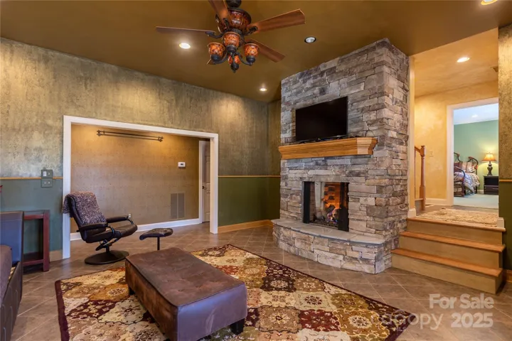 Lower level den has gas fireplace and logs and separates the two lower bedrooms for added privacy. 