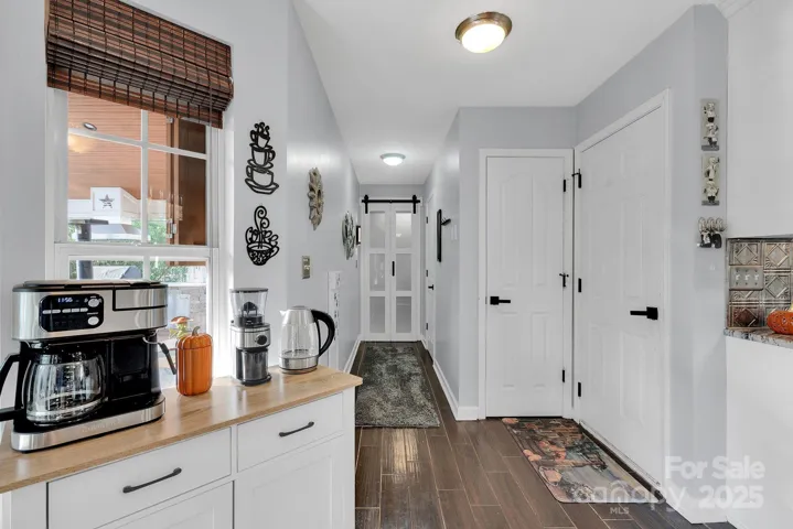 Kitchen area leading to powder room and laundry room