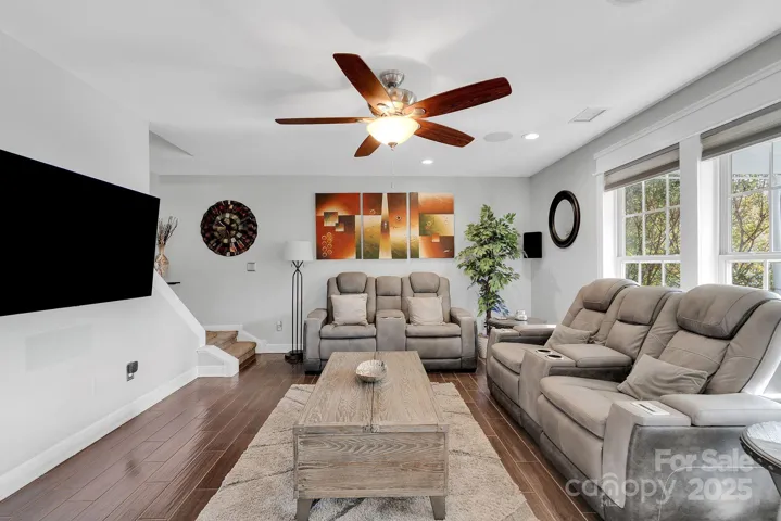 Living room with hidden stairs leading upstairs
