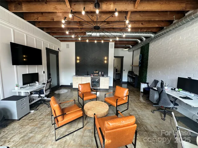 Main office space with accent walls, coffee bar, wine fridge, wet bar, etc.