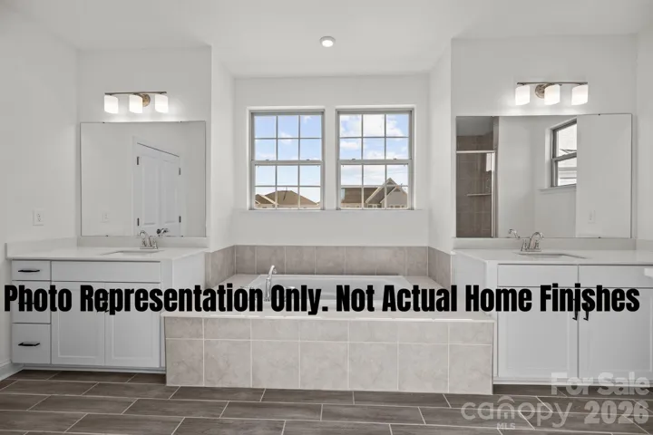 Primary Soaking Tub and Separate Vanities