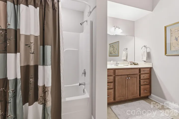 Shower/tub combination and vanity in full bathroom