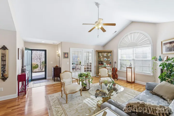 Welcoming home with wood finished floors and arch windows