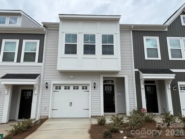 Exterior of Home featuring driveway and 1-car garage