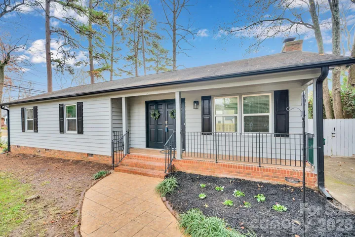 A beautifully maintained home with fresh curb appeal, mature landscaping, and a welcoming front entry.