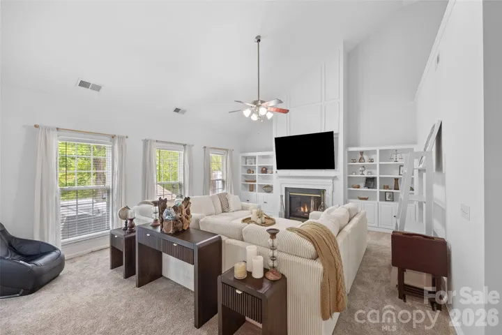 Gas fireplace, built-ins and vaulted ceilings in living room