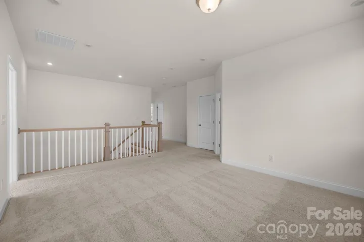 Expansive loft offers versatile space for a media room, playroom, or home gym.