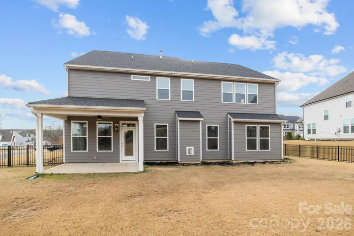 Covered patio and porch create the perfect setting for outdoor dining and entertaining. Level yard offers endless possibilities for outdoor living.