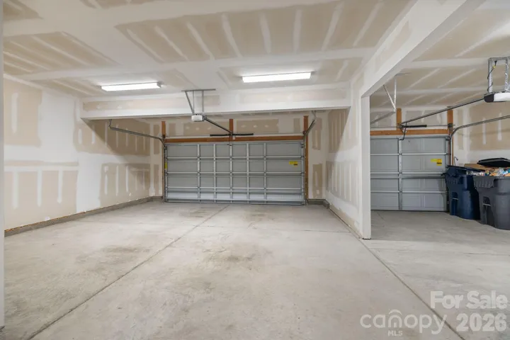 Three-car garage offers exceptional space for vehicles, storage, and outdoor gear.