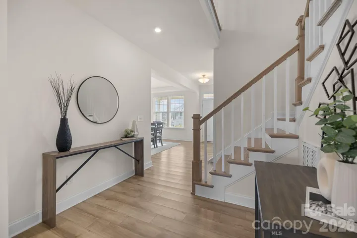 Open staircase and upper landing enhance the home’s spacious feel and thoughtful design.