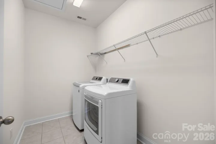 Upper-level laundry room adds everyday convenience close to the bedrooms.