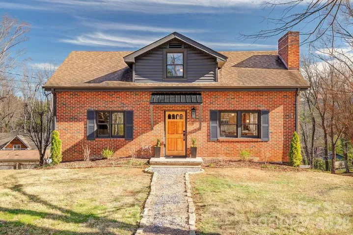 Classic brick exterior with newly painted grey shutters and accents.