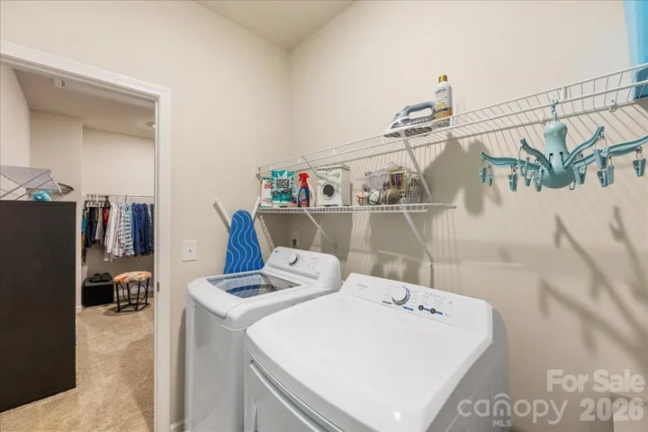 Laundry room connects to the primary closet and upstairs hallway