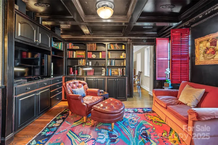 Keeping room with built-ins between the dining room and the primary suite